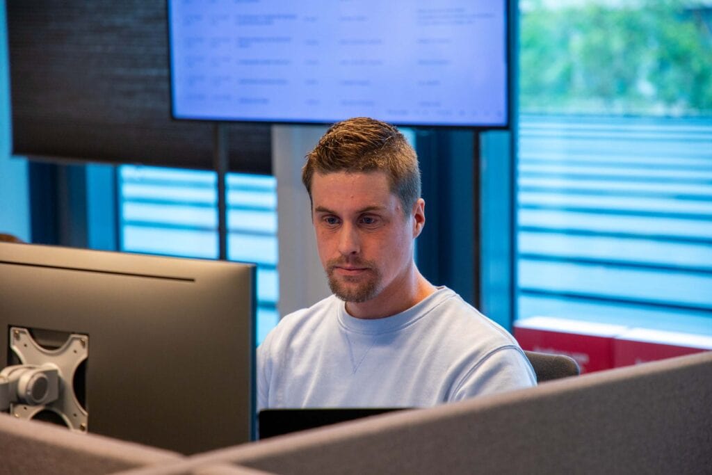 A man sitting at a desk in front of a computer